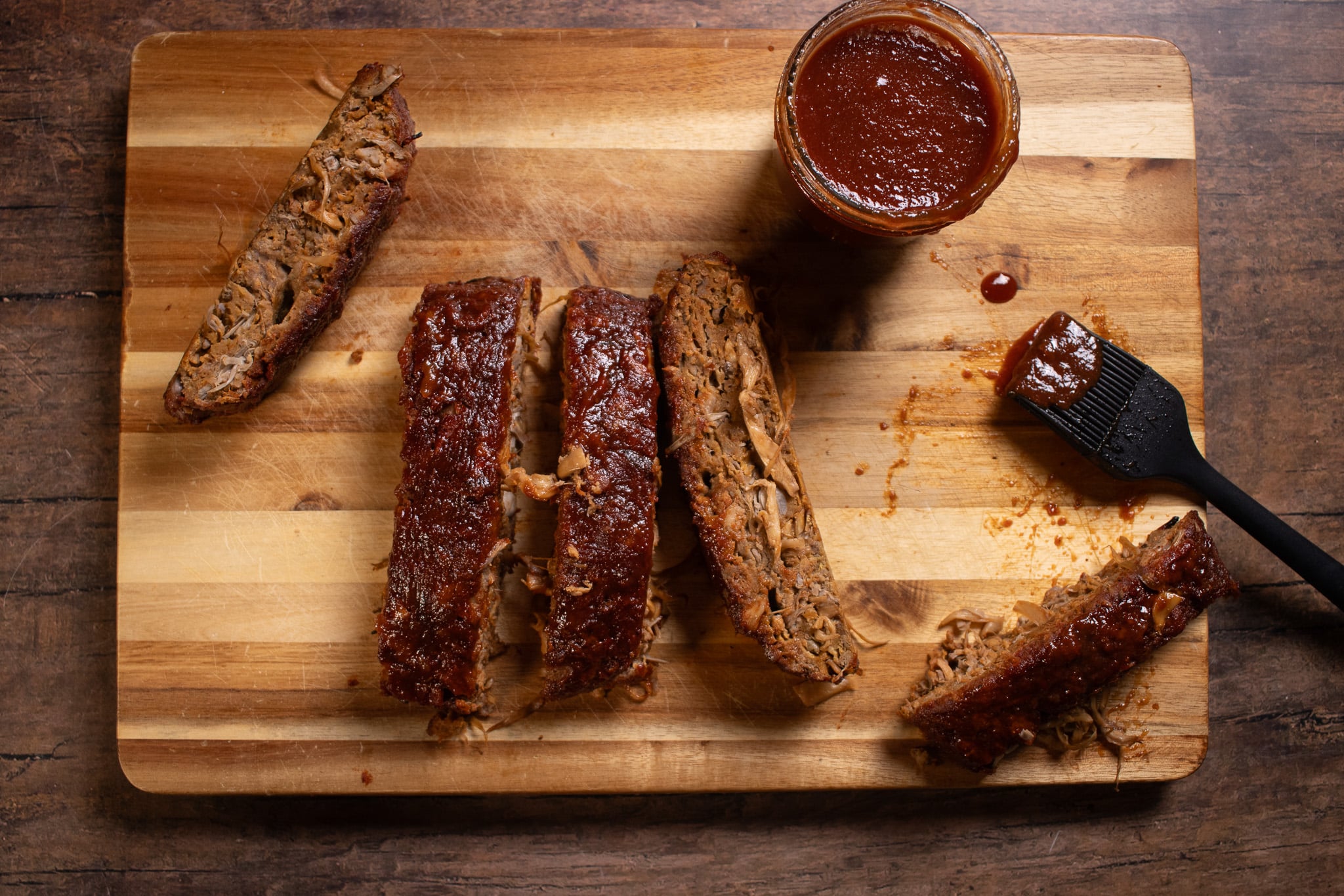 vegan ribs sliced on a cutting board with BBQ Sauce